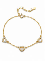 Gold bracelet with heart-shaped charms on a white background