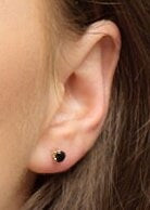 Model wearing gold filled black spinel stud earrings.