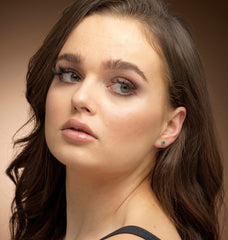 Model wearing gold filled green onyx stud earrings.