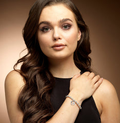 Model wearing silver bead world map bracelet.