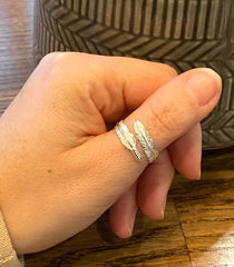 Model wearing solid silver adjustable feather ring.