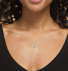 Close up of model wearing Bijou Betty’s 925 sterling silver daughter necklace, featuring three interlinked rings with cubic zirconia, on a 16–18 inch adjustable chain, styled elegantly.