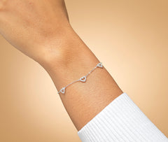 Model wearing sterling silver 30th birthday CZ heart bracelet.