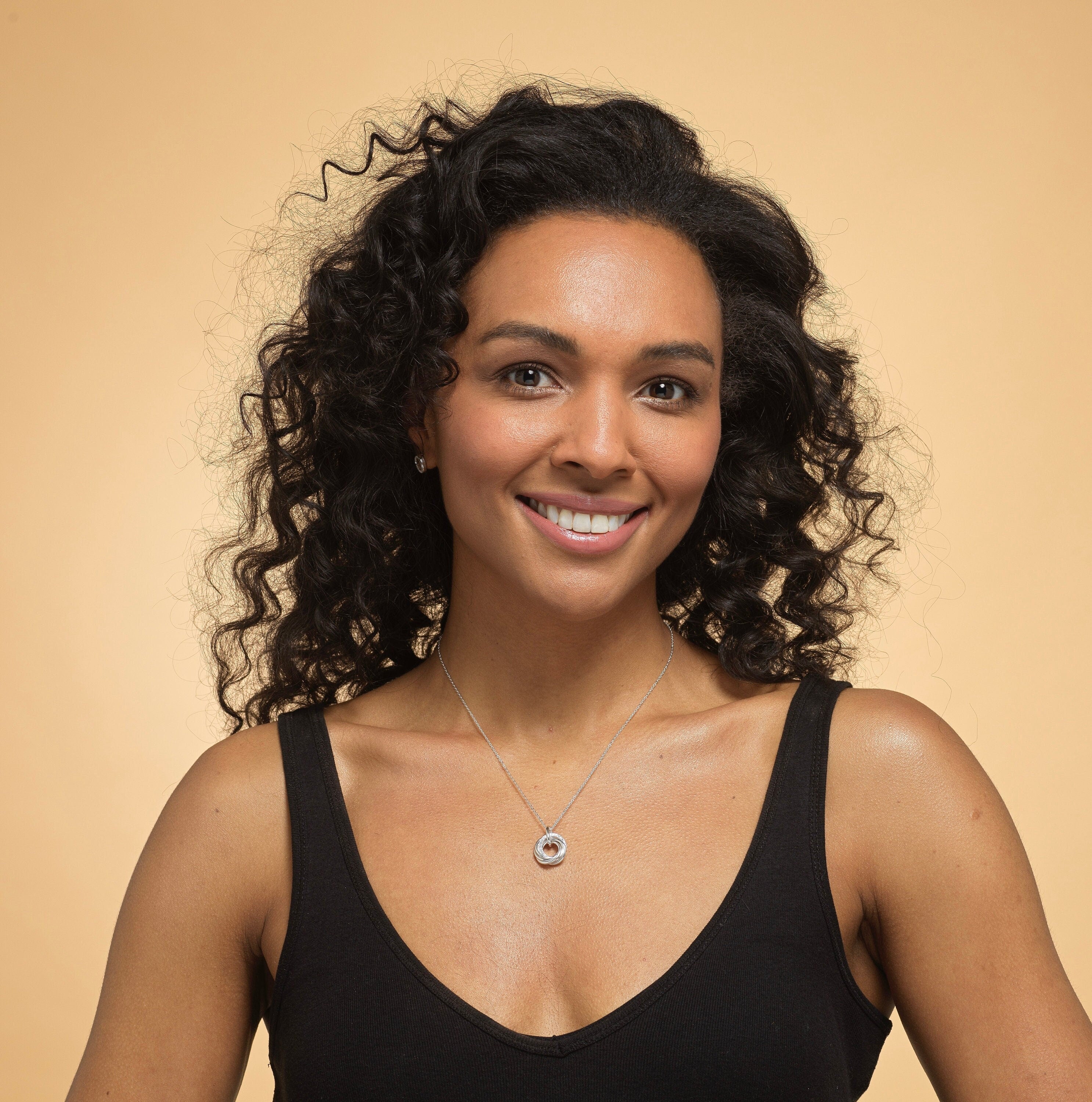 Model wearing sterling silver 60th birthday 6 ring necklace.