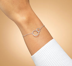Model wearing sterling silver daughter circle bracelet.