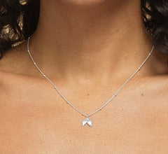 Model wearing sterling silver 17th birthday angel necklace.