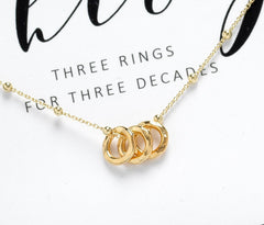 Gold plated 30th birthday ring necklace with three circles.