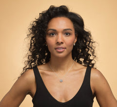 Model wearing Bijou Betty’s 925 sterling silver 18th birthday necklace, featuring three 10mm hearts (“Live, Laugh, Love”) on a 16–18 inch adjustable chain, styled elegantly.