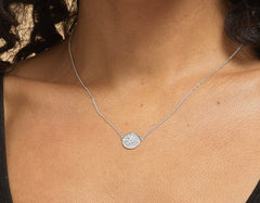Model wearing sterling silver compass necklace.