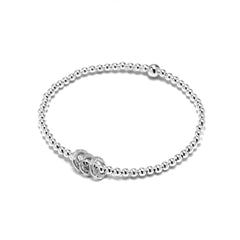 Close-up of Bijou Betty’s 925 silver 30th birthday bracelet with three textured rings and 3mm beads, stretch-fit, on white background.