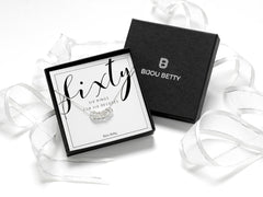 Solid sterling silver 60th birthday necklace featuring 6 hammered rings, each symbolising a decade. Comes with a choice of 16, 18, or 20-inch chain. Includes a gift box, bag, and tissue paper, perfect for celebrating 6 decades of life.