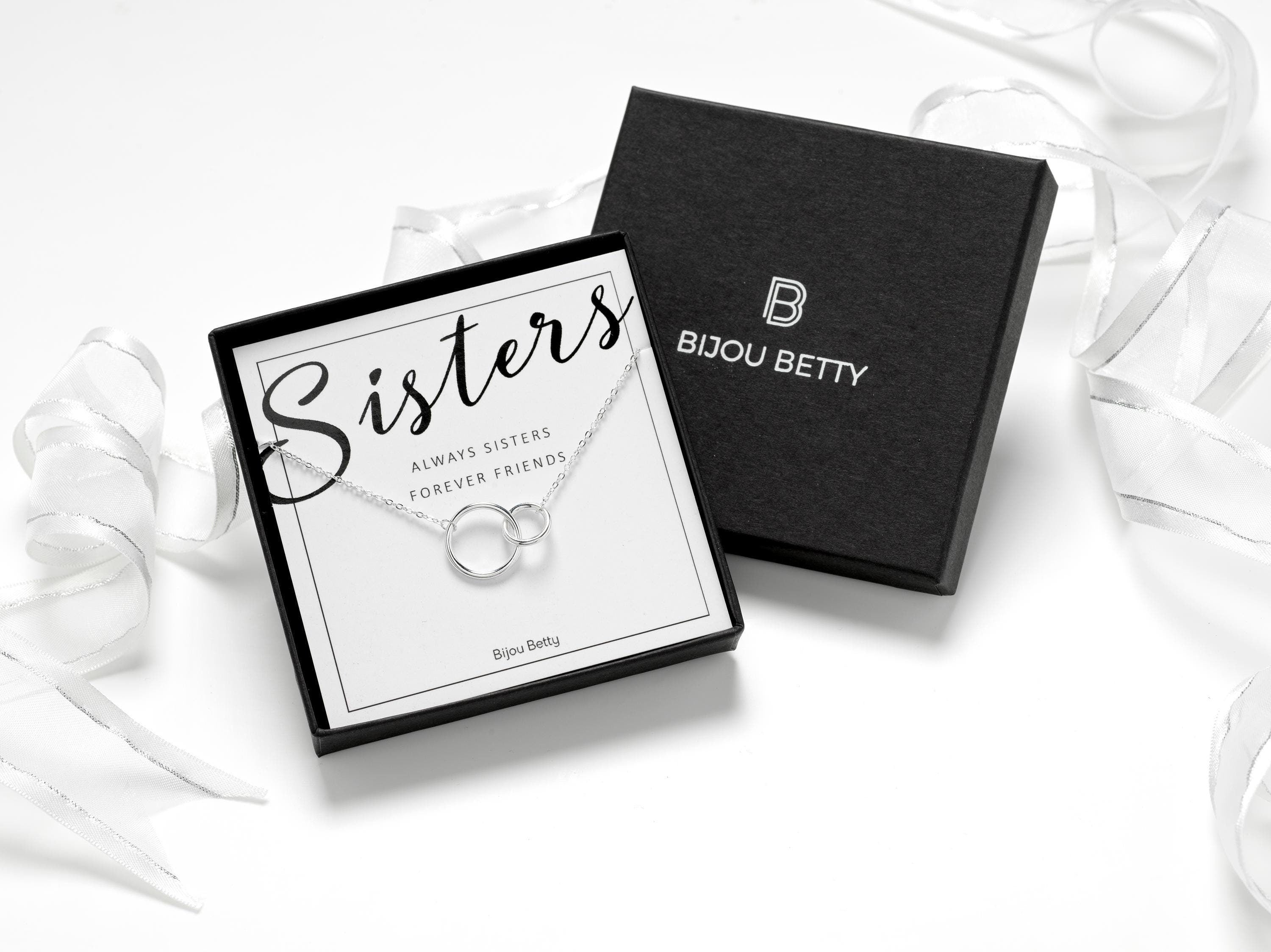 Sterling silver necklace or bracelet with interlinked circles, symbolising sisterly bonds. Adjustable sizes and includes gift box, tissue paper, and a message card. Perfect gift for sister on birthdays, Christmas, or any special occasion.
