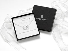 Sterling silver interlinked necklace or bracelet with two circles, adjustable length, presented in a Bijou Betty gift box with a matching bag. Includes a card reading, 'Chance made us colleagues, but fun made us friends.' A thoughtful, timeless gift.