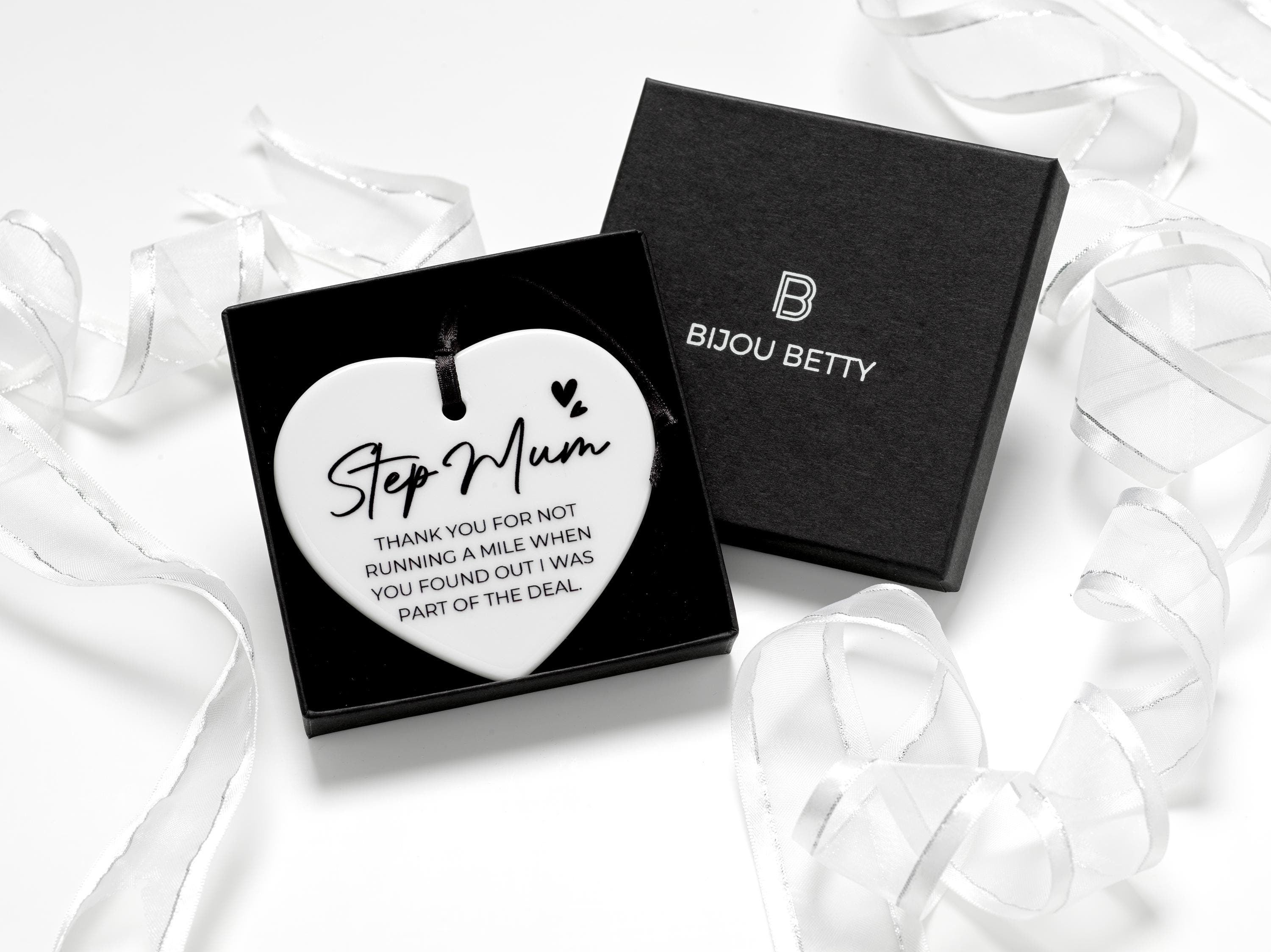 Ceramic heart keepsake with black ribbon, featuring the message: Step mum - thank you for not running a mile when you found out I was part of the deal. Perfect gift for step mum's birthday, Christmas, or just because. Optional gift box available.