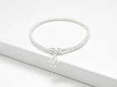 Solid sterling silver turtle charm stretch bead bracelet. Presented in luxury gift packaging which includes gift box, matching bag, tissue paper and ribbon.