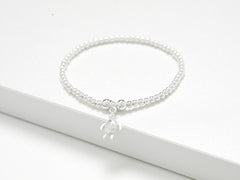 Solid sterling silver turtle charm stretch bead bracelet. Presented in luxury gift packaging which includes gift box, matching bag, tissue paper and ribbon.