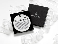 Ceramic round friendship gift (75mm diameter) with best friend quote and black satin ribbon, wrapped in tissue paper, optional gift box or bag.