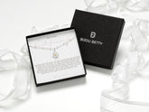 Sterling silver daisy necklace with gold-plated centre, 12mm pendant, 16-18 inch chain, in Bijou Betty gift box.