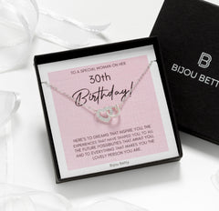 Close up of sterling silver heart necklace with cz stones.