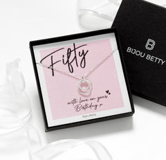 Model wearing silver 50th birthday necklace.