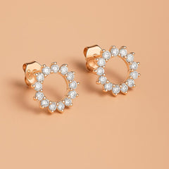 Close-up of Bijou Betty’s 925 silver sunburst stud earrings, 10mm with cubic zirconia with rose gold plate.