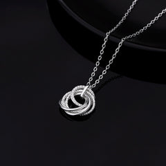 Close-up of a 925 sterling silver 5 ring decades necklace with five interlocked rings, one featuring sparkling cubic zirconia stones, on a white background.