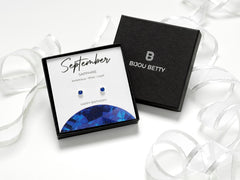 Sterling silver 4mm sapphire-style CZ stud earrings in Bijou Betty gift box with September birthstone card.
