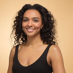 Model wearing rose gold heart necklace.