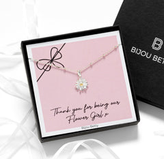 Sterling silver daisy necklace with gold-plated centre on satellite chain, displayed in luxury gift box.