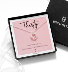Close-up of a sterling silver 30th birthday necklace by Bijou Betty, featuring three interlinked 925 silver rings—one plain, one textured, one with cubic zirconia—on a 16–18 inch adjustable chain.