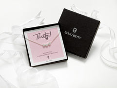 Bijou Betty’s 30th birthday necklace gift set, with a 925 sterling silver three-heart necklace, in a gift box with ribbon, tissue, and a card reading, Thirty! WISHING YOU A VERY HAPPY 30TH BIRTHDAY!