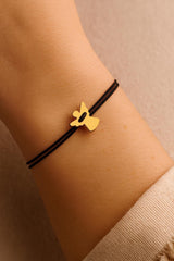 A model wearing a stainless steel angel on a black cord bracelet, perfect for sympathy or birthday gifts.