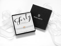 Bijou Betty’s decades bracelet gift set, 925 silver and rose gold rings, in gift box with bag, tissue, and card: “Forty: 4 rings for 4 decades.