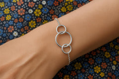 Model wearing a Sterling silver 3-ring generations bracelet, ideal for grandmothers.