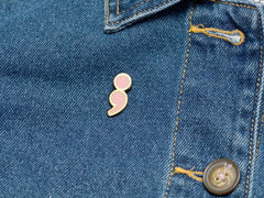 Pink enamel pin on jacket, 25.5mm, Your Story Continues, Bijou Betty gift for friend’s new chapter.