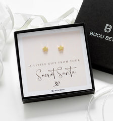 Close-up of gold-plated star earrings, perfect for Secret Santa gifts for colleagues or sisters.