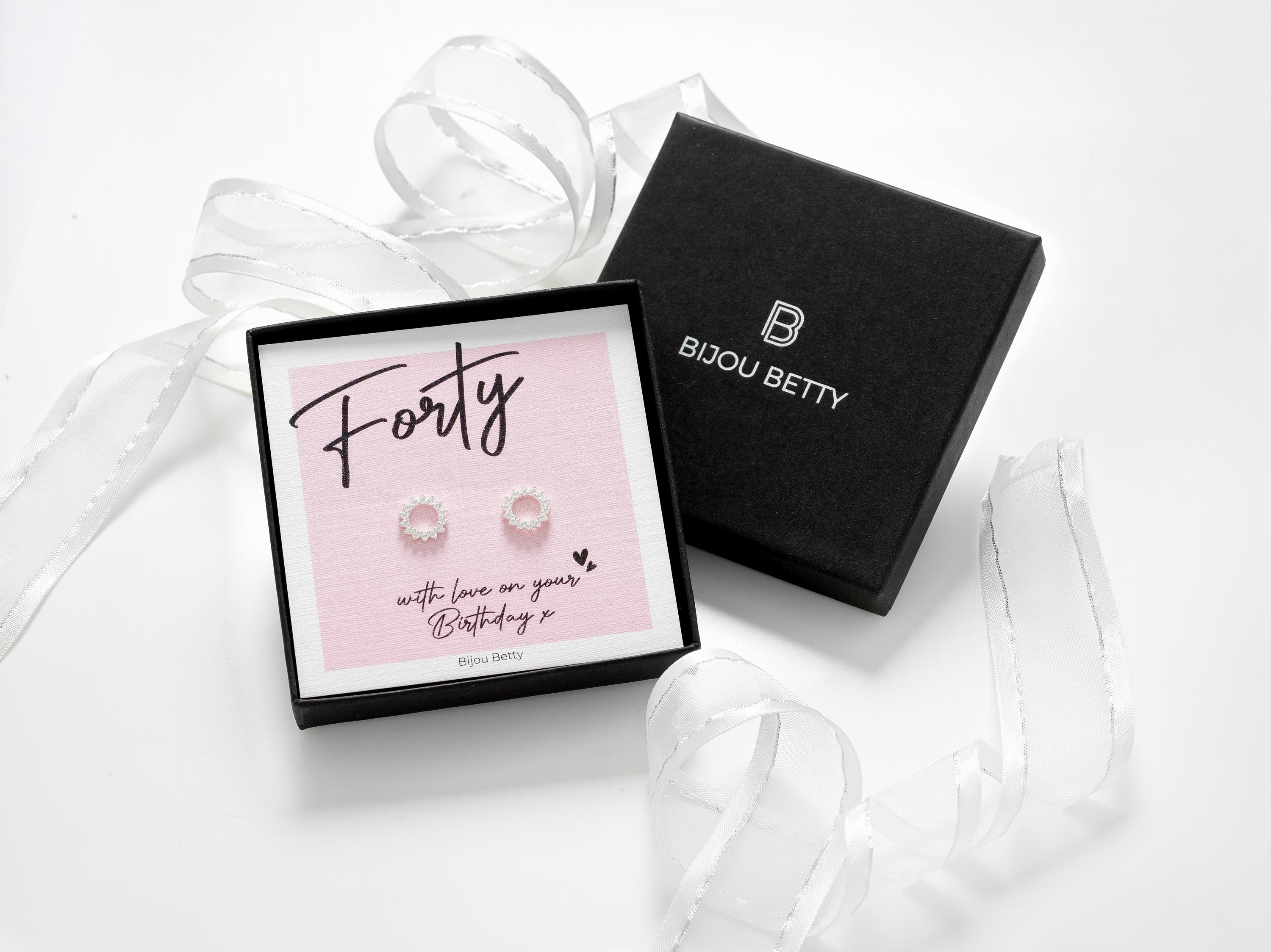 40th Birthday solid silver sunburst earrings with cubic zirconia stones. Presented in a gift box and tissue paper.