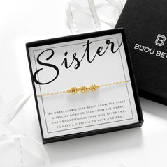 Close-up of a gold 3 heart bracelet, perfect for a little sister birthday gifts.