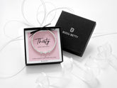 Sterling silver 30th birthday bracelet with three heart beads, dainty stretch design with polished silver beads, meaningful three decades gift for her, displayed on pink background, gift boxed jewellery by Bijou Betty