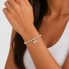 Sterling silver stretch bead bracelet with bow charm