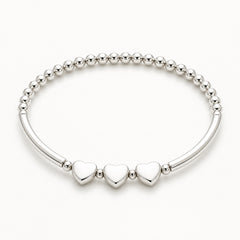 Silver 30th birthday bracelet with heart-shaped charms on a white background