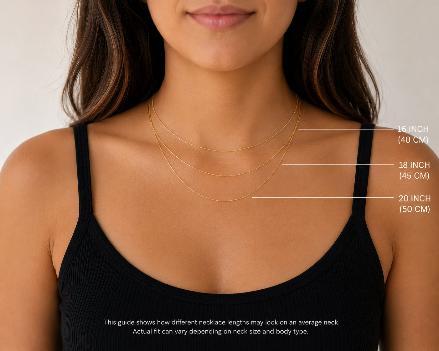 Woman wearing a necklace with measurements indicated on a plain background