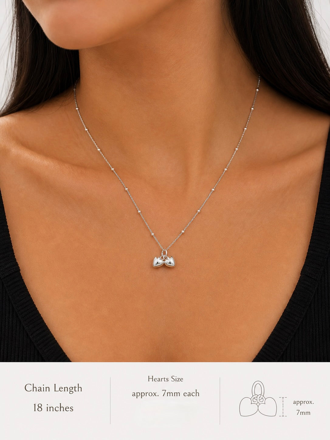 Necklace with heart pendants on a model, showing chain length and heart size details.