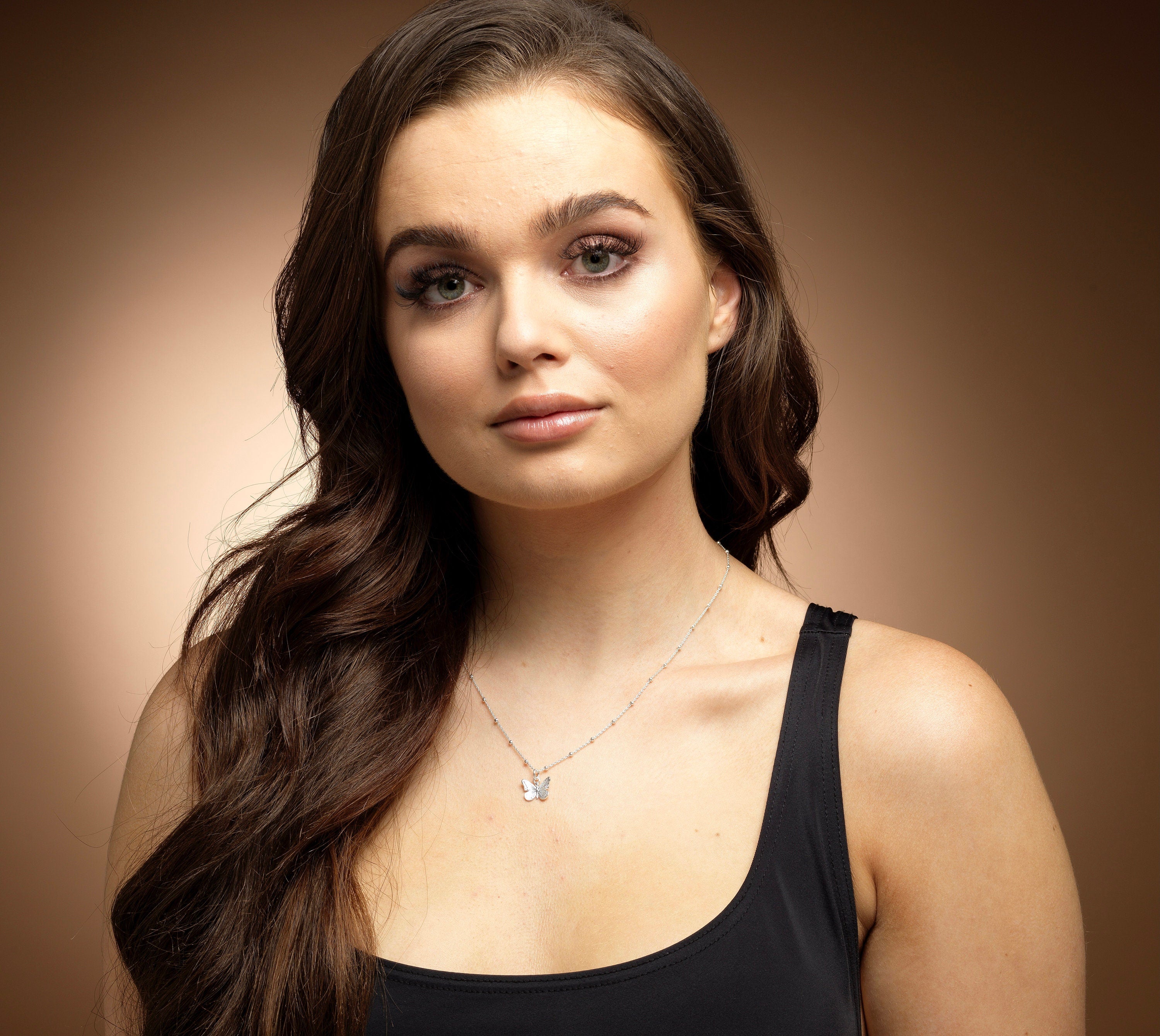 Model wearing Bijou Betty’s 925 silver butterfly necklace, 13mm x 11mm pendant on 16–20 inch chain, styled elegantly.
