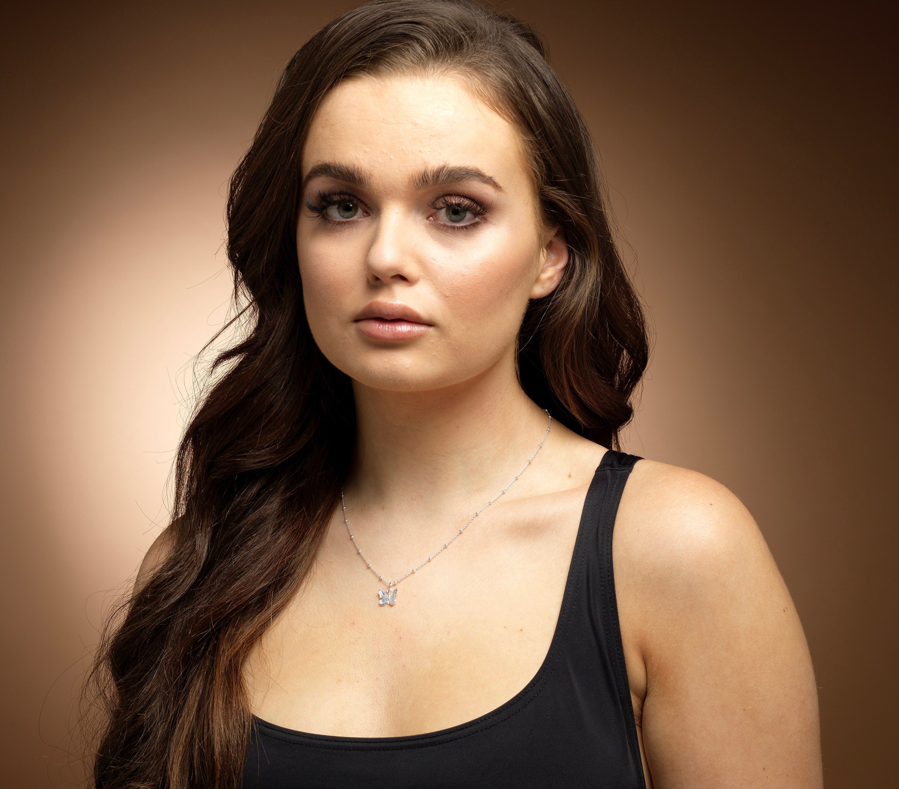 Model wearing sterling silver butterfly necklace.