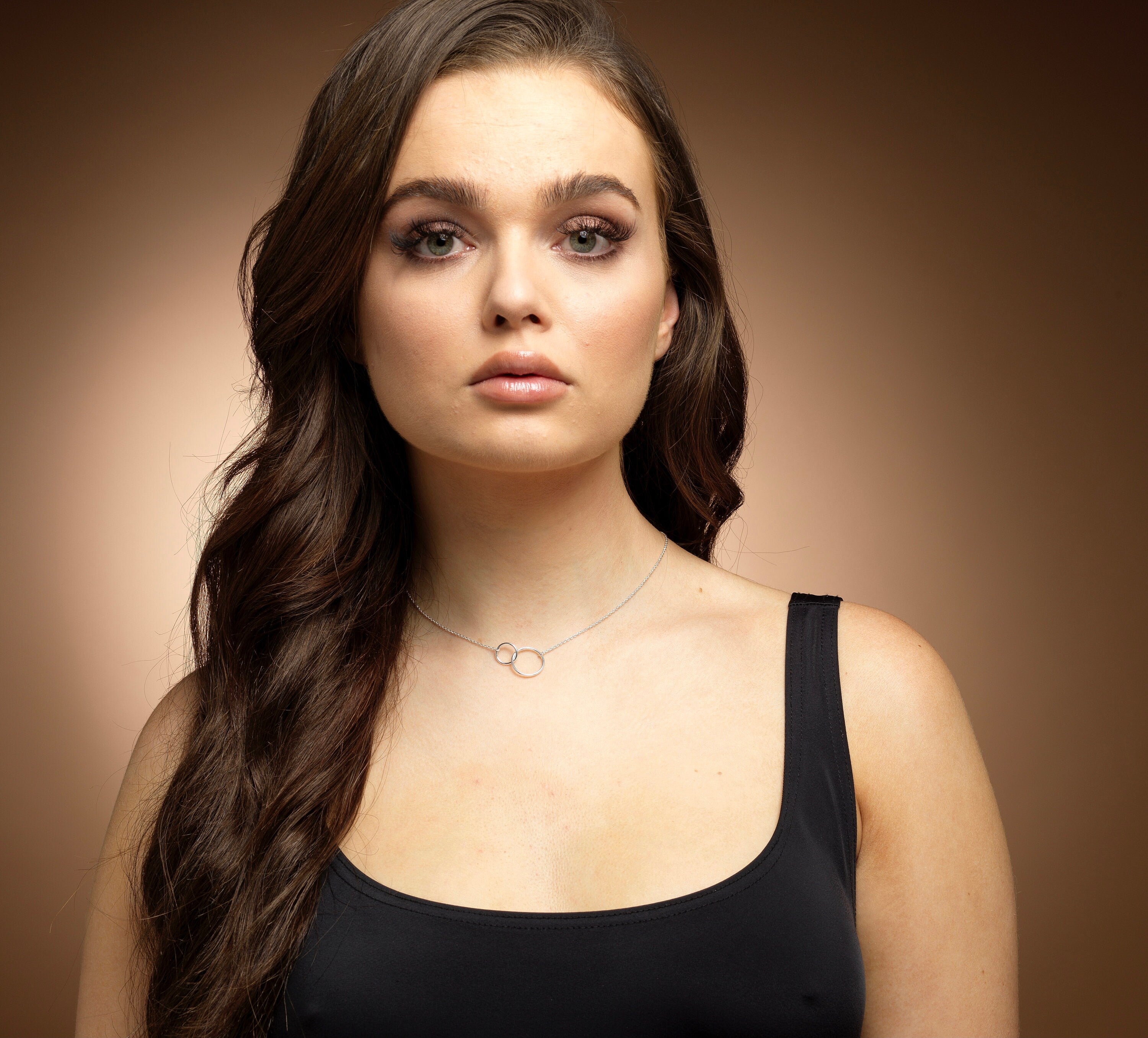 Model wearing a sterling silver interlinked circles necklace.