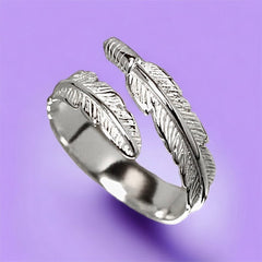 A close up of silver feather wrap ring.