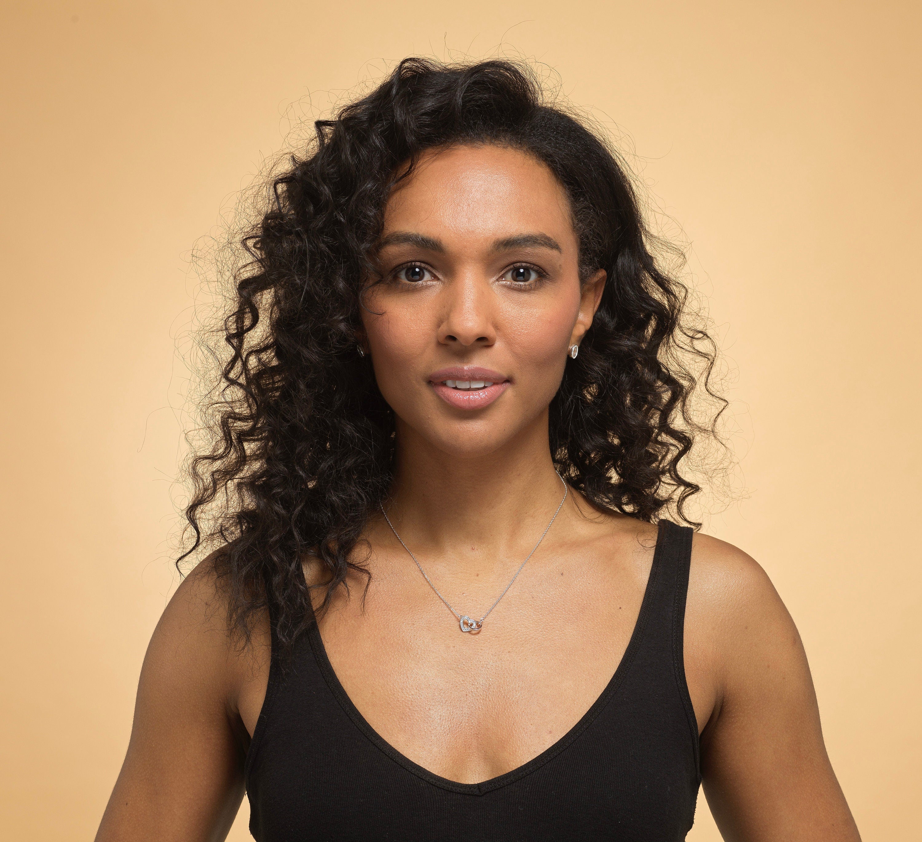 Model wearing Bijou Betty’s 925 silver mother daughter necklace, 18mm x 10mm heart and circle with cubic zirconia, on 16–18 inch chain, styled elegantly.