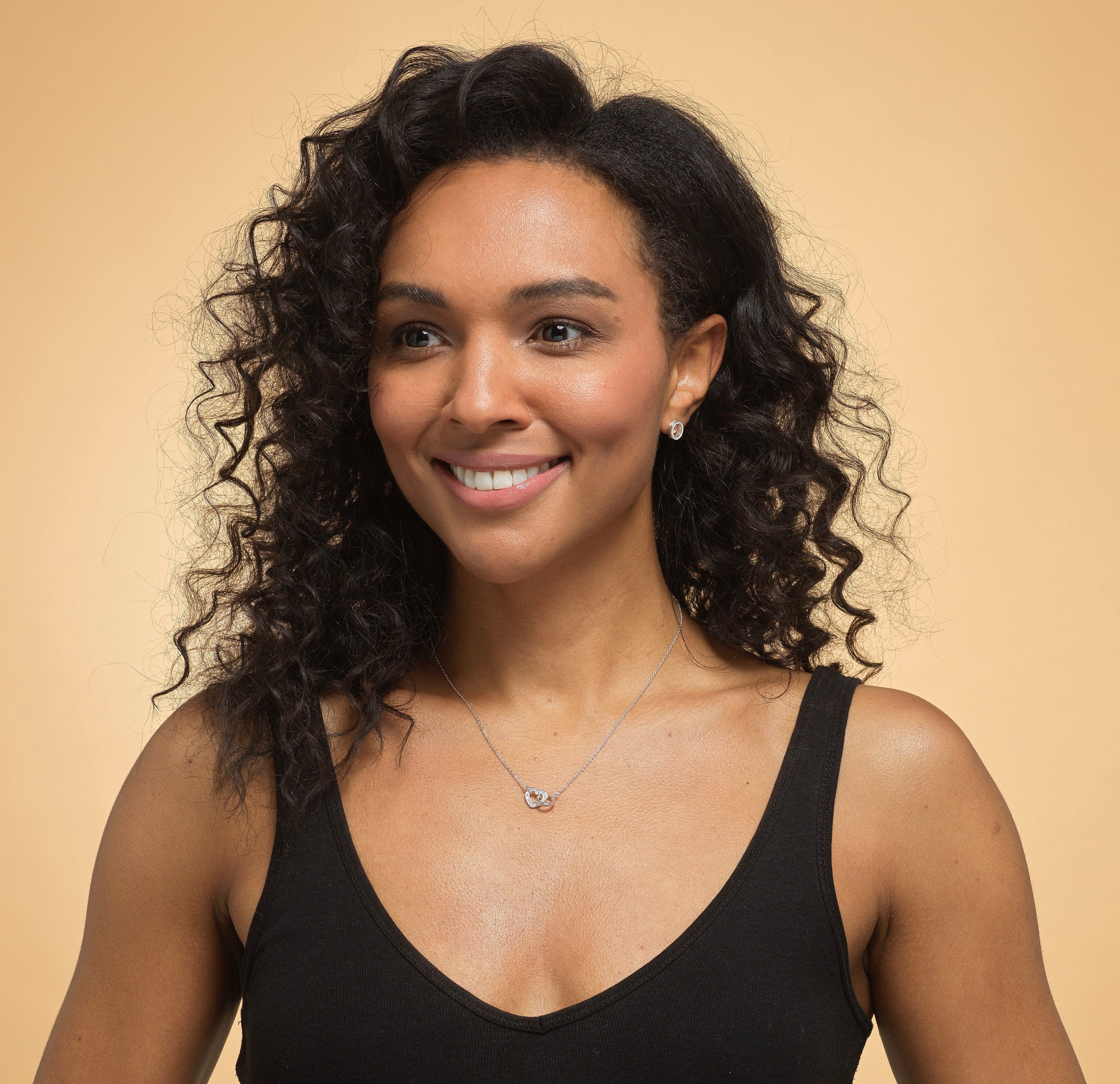 Model wearing Bijou Betty’s 925 silver mother daughter necklace, 18mm x 10mm heart and circle with cubic zirconia, on 16–18 inch chain, styled elegantly.