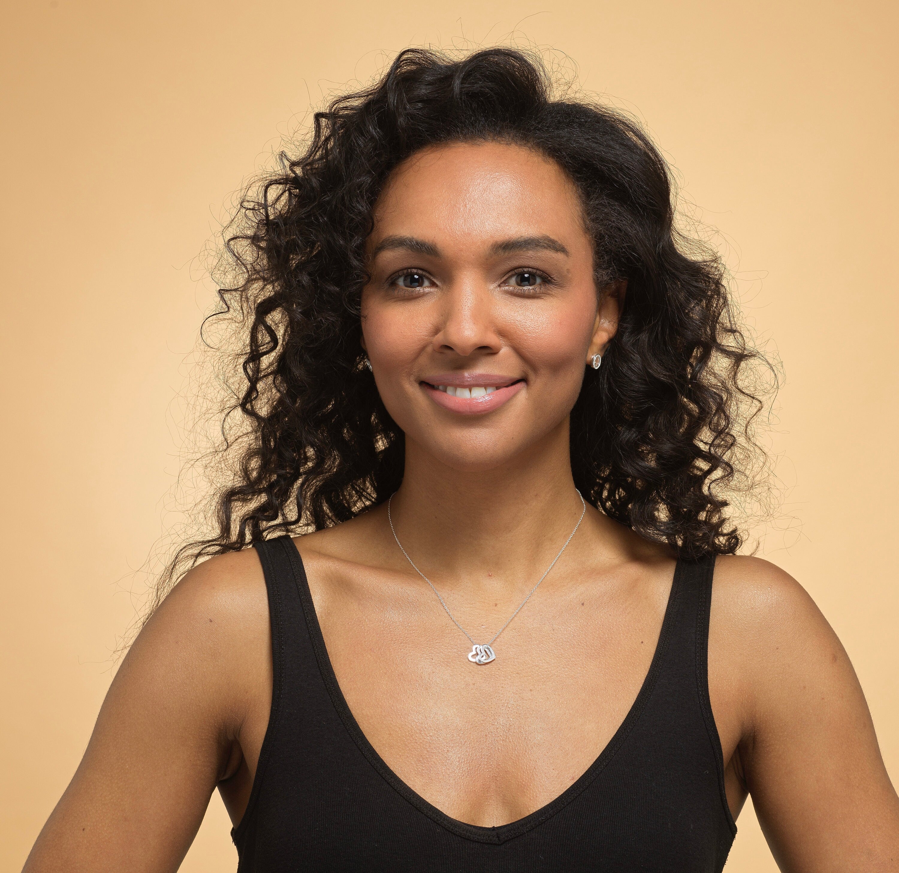 Model wearing Bijou Betty’s 925 sterling silver 18th birthday necklace, featuring three 10mm hearts (“Live, Laugh, Love”) on a 16–18 inch adjustable chain, styled elegantly.